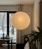 Grand Akari Washi Ceiling Lamp lit over a dining table in a winter-lit living room — Captains Bamboo