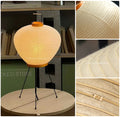 Akari 3A Table Lamp — lit lamp on a round wood table in a shop, washi detail insets — Captains Bamboo