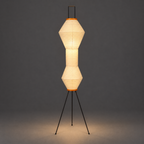 Akari 12A Washi Floor Lamp — both shades lit and glowing warm, light falling on the floor below them — Captains Bamboo