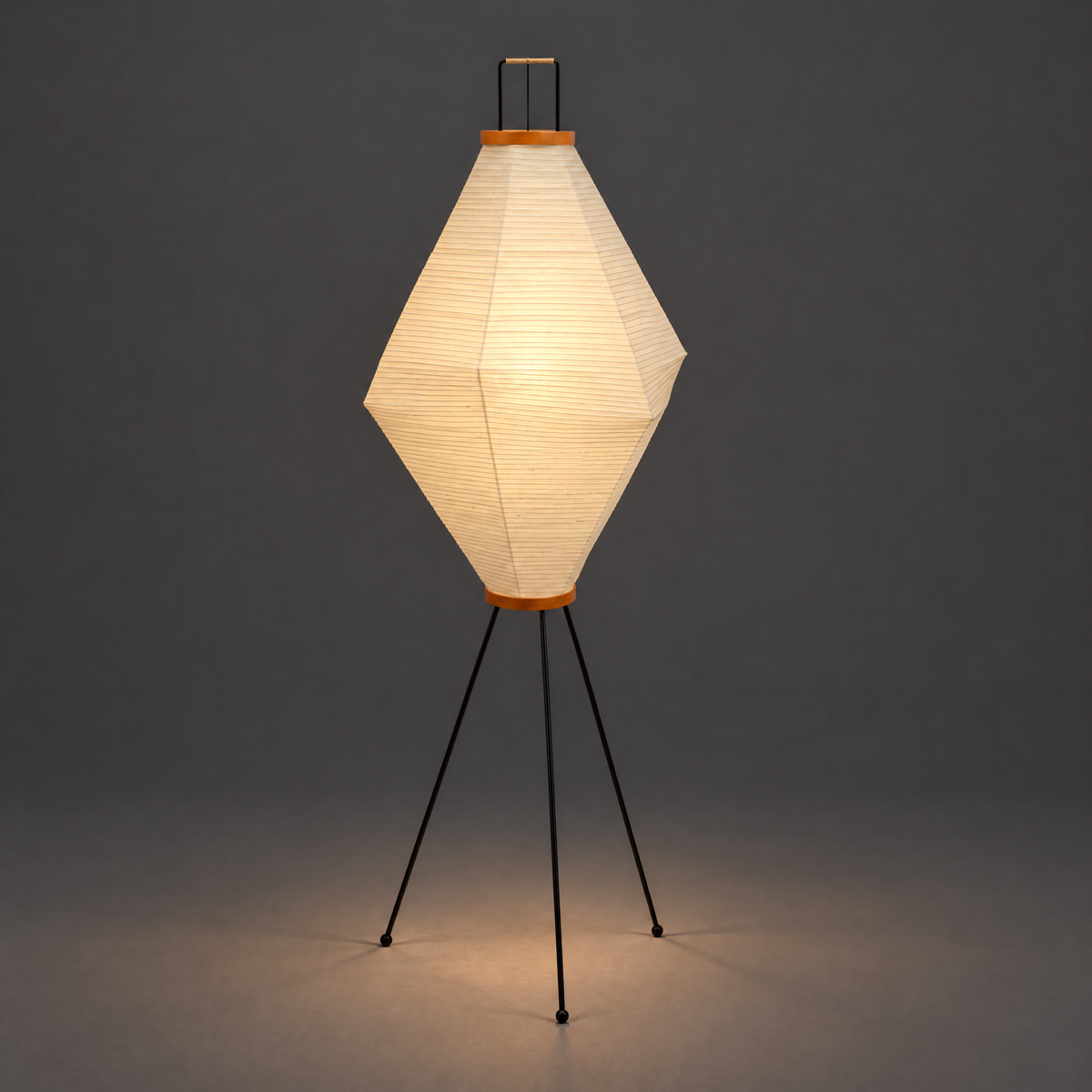Akari 13A Washi Floor Lamp — diamond shade lit and glowing, warm light spilling onto the floor — Captains Bamboo