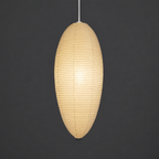 Akari 23A Washi Pendant — lit oval shade glowing through the washi paper — Captains Bamboo