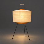 Akari 6A Washi Table Lamp — lit drum shade glowing warm in a dark studio, light spreading on the floor — Captains Bamboo