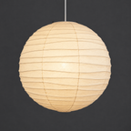 Akari 75D Pendant — the same shade lit, glowing warm with the bamboo ribs showing through — Captains Bamboo