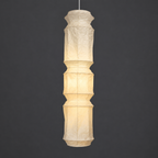 Akari L6 Paper Ceiling Lamp — lit stacked paper lantern shade glowing warm on a gray studio background — Captains Bamboo